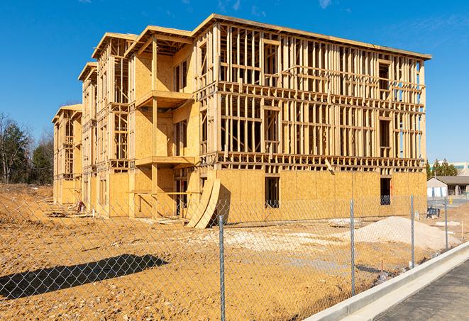 a temporary chain link fence winding around a construction site, outlining the project's progress in North Highlands, CA